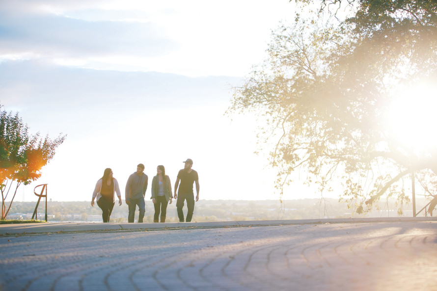 Friends in park at sunset